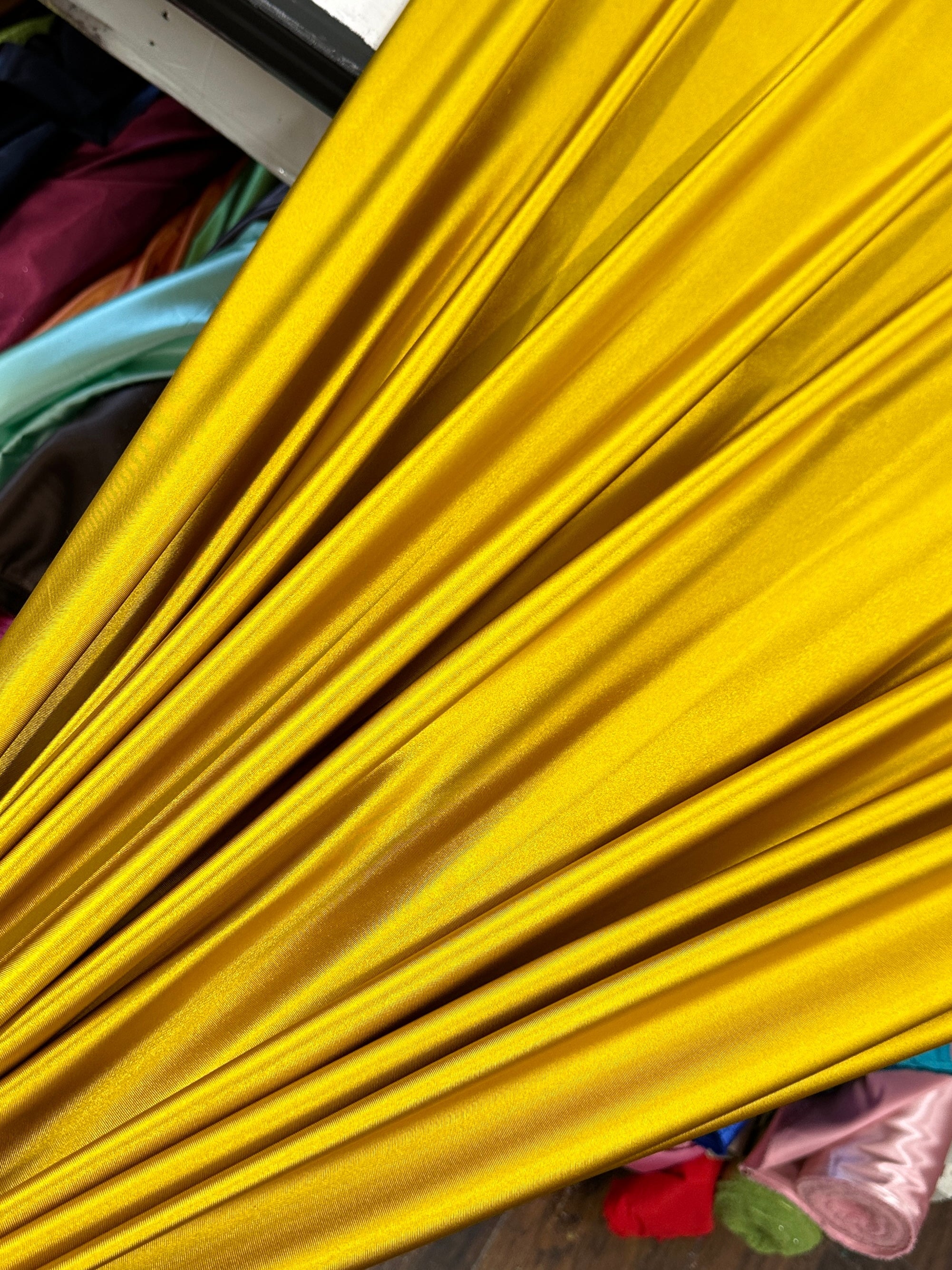 mustard shiny nylon spandex, gold shiny nylon spandex, gold milliskin fabric, yellow shiny nylon spandex, yellow spandex, 4 way stretch spandex, lycra spandex. activewear fabric, athleisure fabric