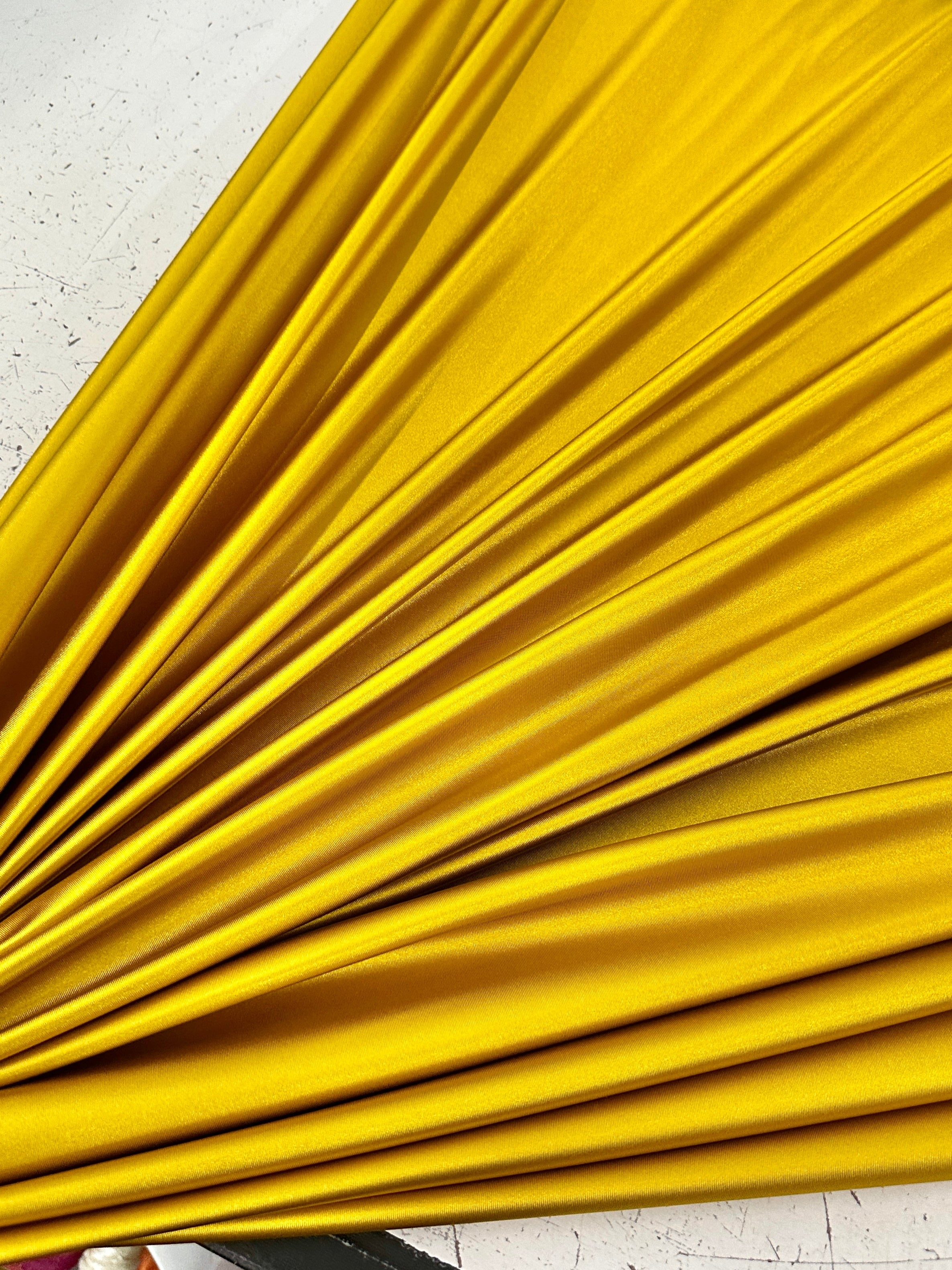 mustard shiny nylon spandex, gold shiny nylon spandex, gold milliskin fabric, yellow shiny nylon spandex, yellow spandex, 4 way stretch spandex, lycra spandex. activewear fabric, athleisure fabric