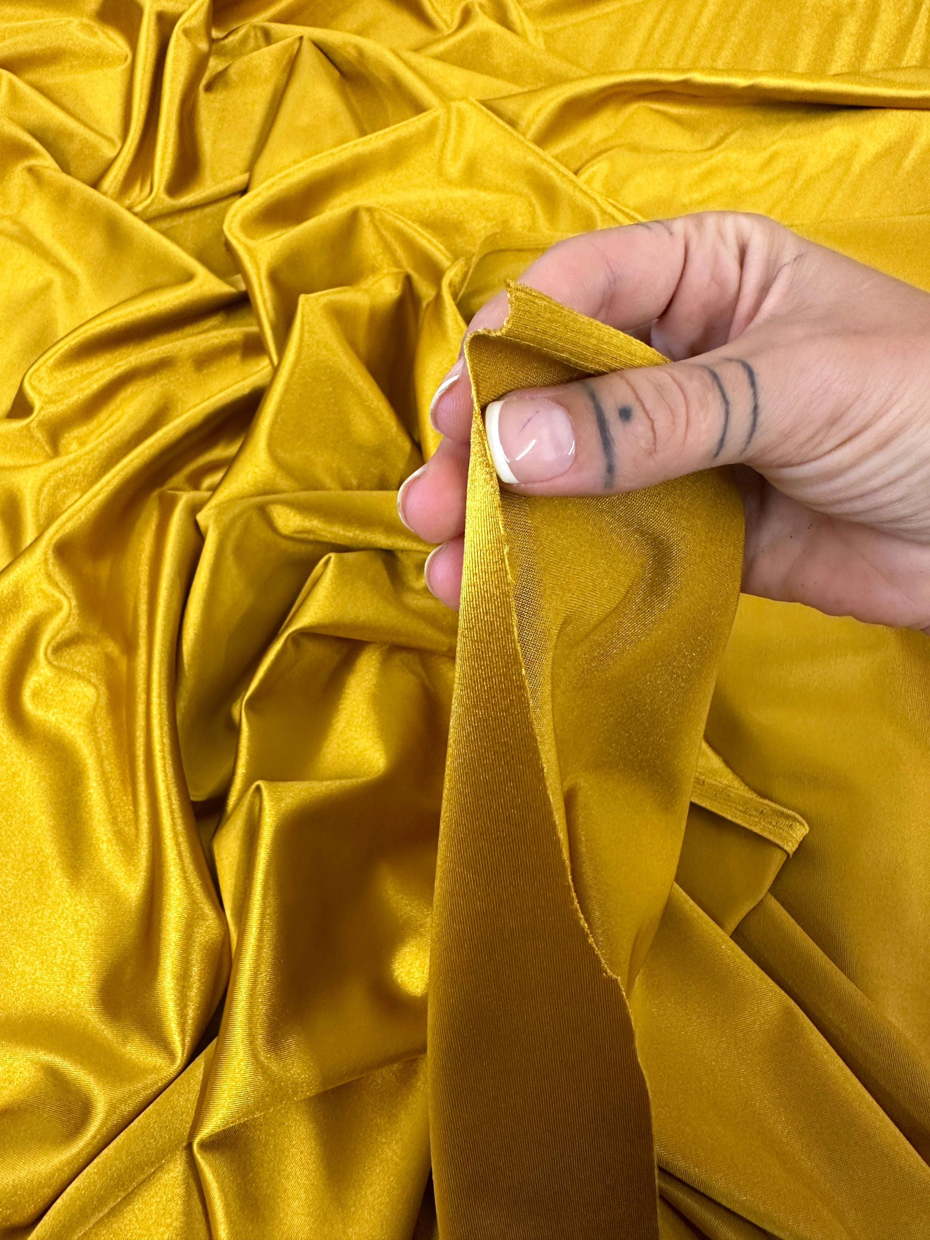 mustard shiny nylon spandex, gold shiny nylon spandex, gold milliskin fabric, yellow shiny nylon spandex, yellow spandex, 4 way stretch spandex, lycra spandex. activewear fabric, athleisure fabric