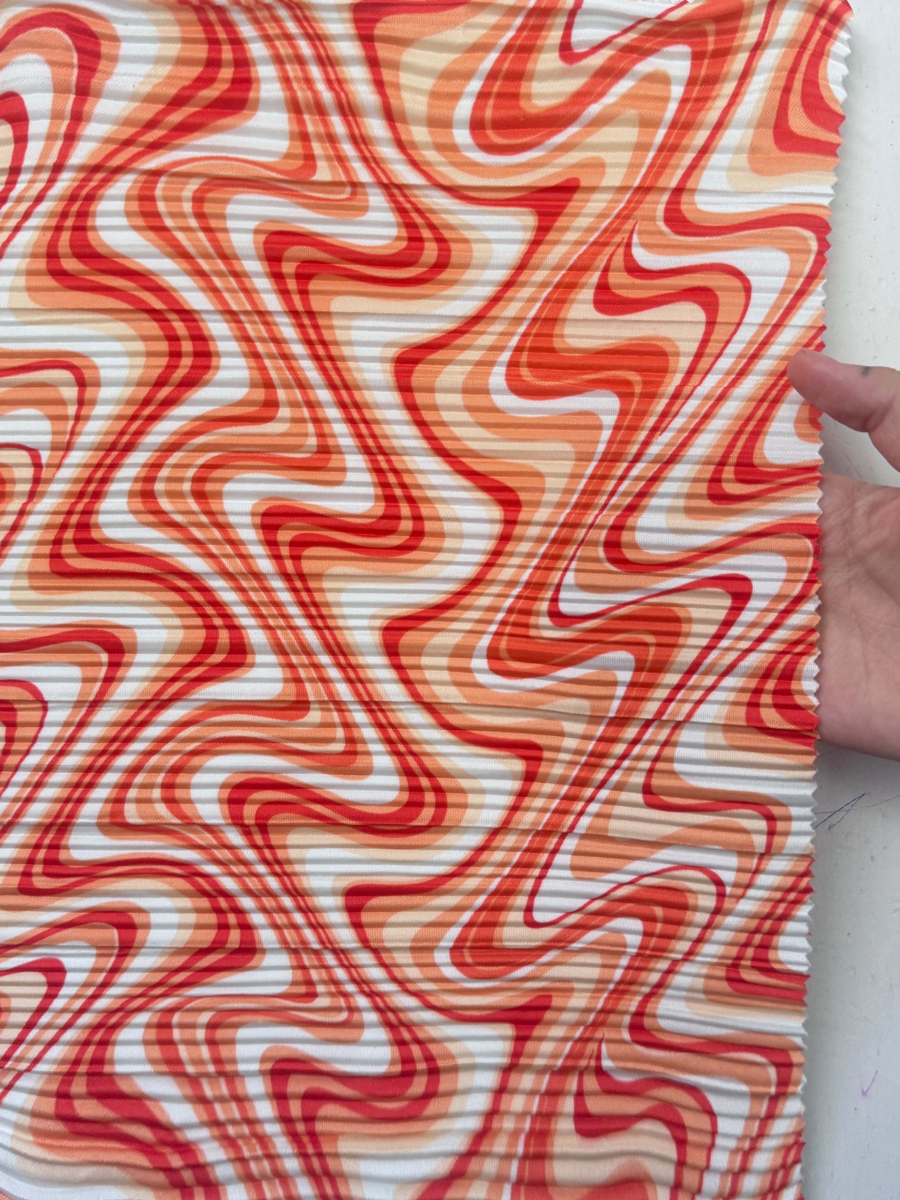 orange print Pleated Knit, orange pleated knit, orange textured knit, printed fabric, print pleated fabric, pleated spandex, spandex fabric, kiki textiles, sewing