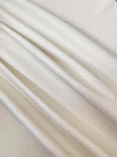 off white stretch Faux Leather, white faux leather, shiny faux leather, bright white faux leather for woman, faux leather for costumes, faux leather for home decor, 2 way stretch faux leather, leather for blazers, cheap leather, discounted leather, leather on sale