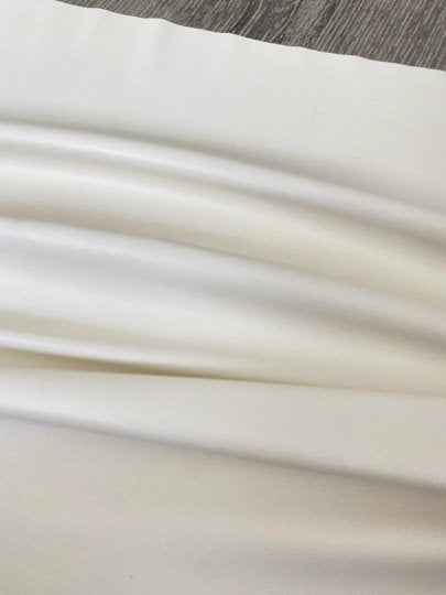 off white stretch Faux Leather, white faux leather, shiny faux leather, bright white faux leather for woman, faux leather for costumes, faux leather for home decor, 2 way stretch faux leather, leather for blazers, cheap leather, discounted leather, leather on sale