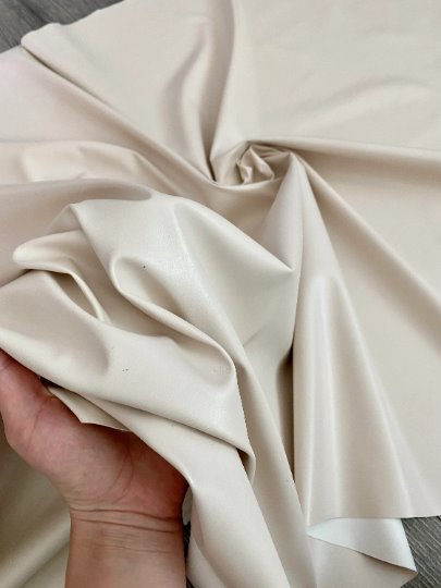 beige stretch faux leather, beige stretch pleather, beige stretch soft vinyl, beige stretch vinyl, faux leather stretch for clothing, Faux Leather for jackets, Faux Leather for bags, Faux Leather on discount, Faux Leather on sale, premium Faux Leather, light color Faux Leather, Faux Leather for tops, Faux Leather for leggings