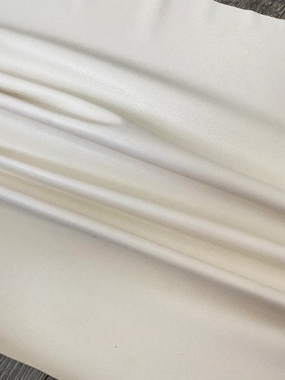 off white stretch Faux Leather, white faux leather, shiny faux leather, bright white faux leather for woman, faux leather for costumes, faux leather for home decor, 2 way stretch faux leather, leather for blazers, cheap leather, discounted leather, leather on sale