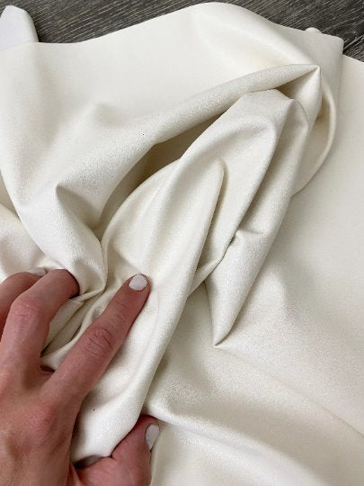 off white stretch Faux Leather, white faux leather, shiny faux leather, bright white faux leather for woman, faux leather for costumes, faux leather for home decor, 2 way stretch faux leather, leather for blazers, cheap leather, discounted leather, leather on sale