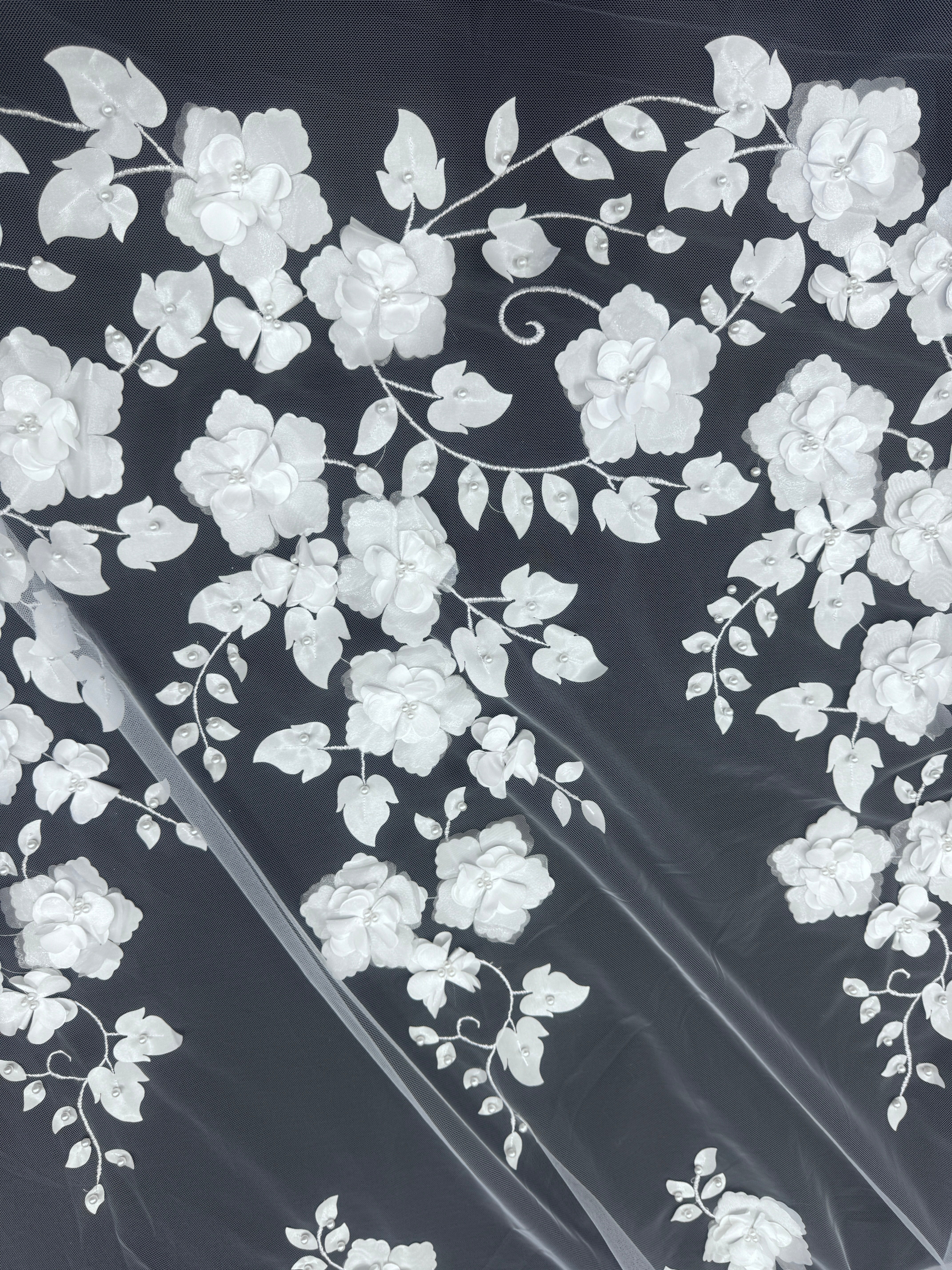 white flowers and leaves pattern with 3d effect and beads on a white sheer fabric. 