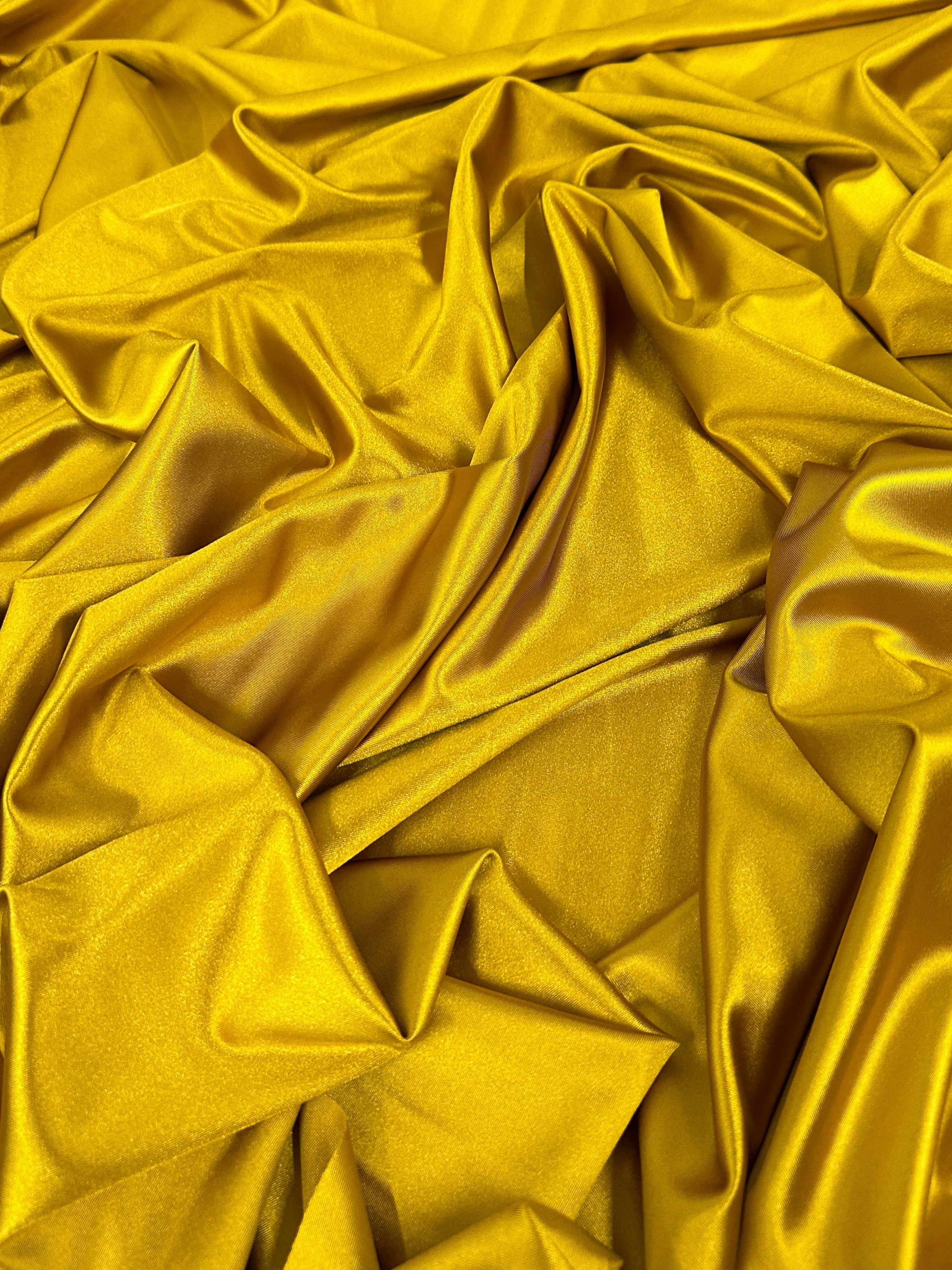 mustard shiny nylon spandex, gold shiny nylon spandex, gold milliskin fabric, yellow shiny nylon spandex, yellow spandex, 4 way stretch spandex, lycra spandex. activewear fabric, athleisure fabric