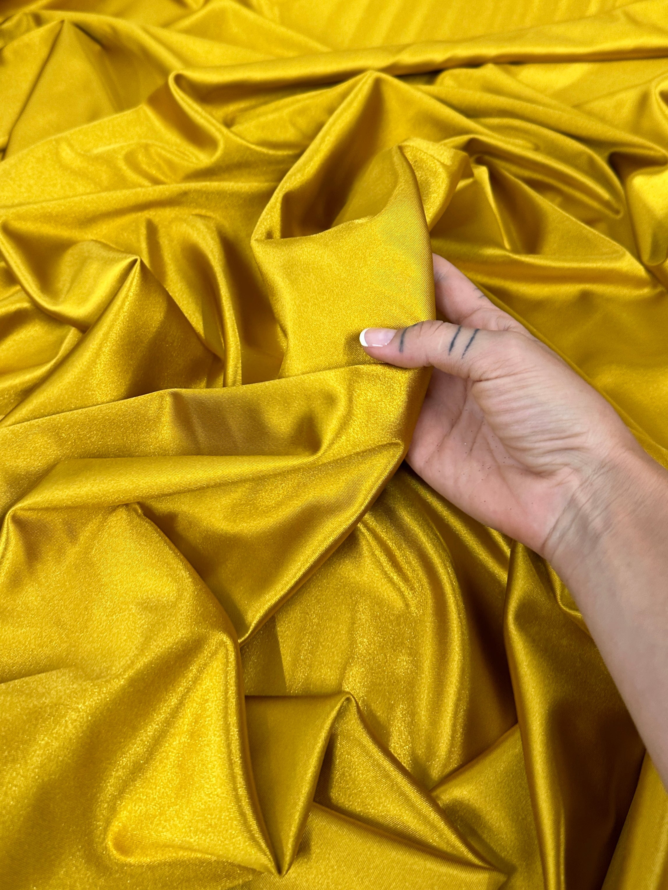 mustard shiny nylon spandex, gold shiny nylon spandex, gold milliskin fabric, yellow shiny nylon spandex, yellow spandex, 4 way stretch spandex, lycra spandex. activewear fabric, athleisure fabric