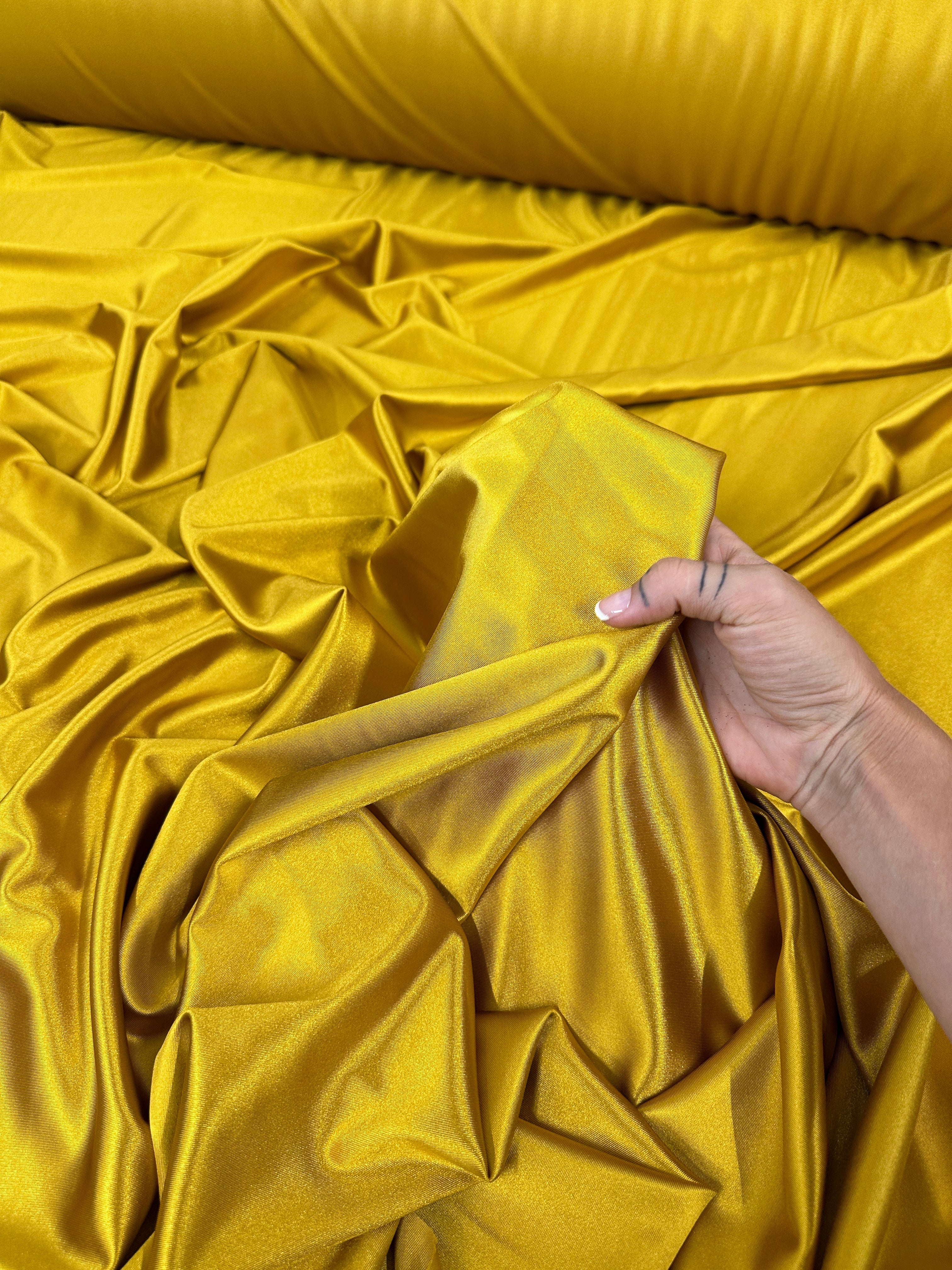 mustard shiny nylon spandex, gold shiny nylon spandex, gold milliskin fabric, yellow shiny nylon spandex, yellow spandex, 4 way stretch spandex, lycra spandex. activewear fabric, athleisure fabric