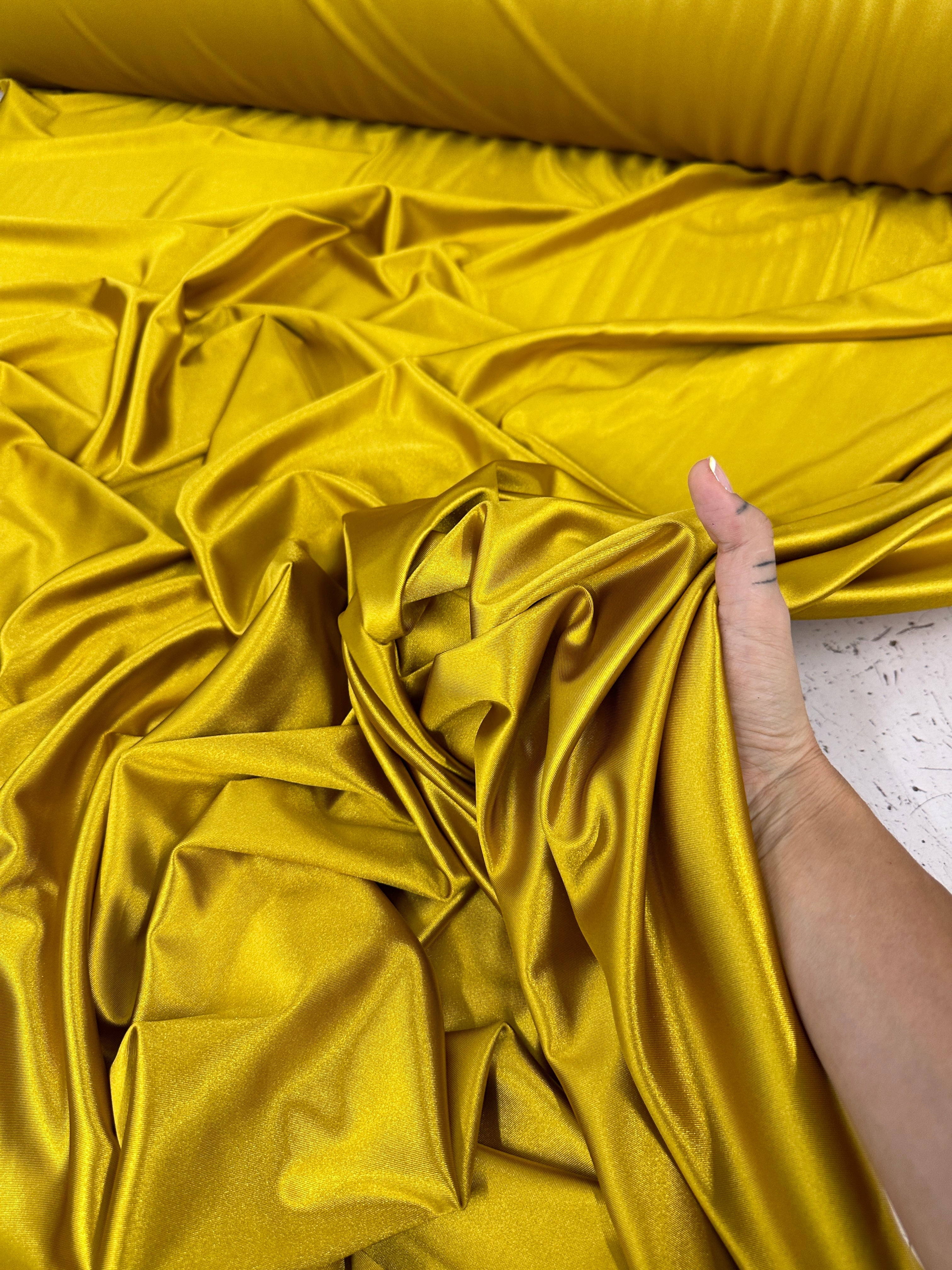 mustard shiny nylon spandex, gold shiny nylon spandex, gold milliskin fabric, yellow shiny nylon spandex, yellow spandex, 4 way stretch spandex, lycra spandex. activewear fabric, athleisure fabric