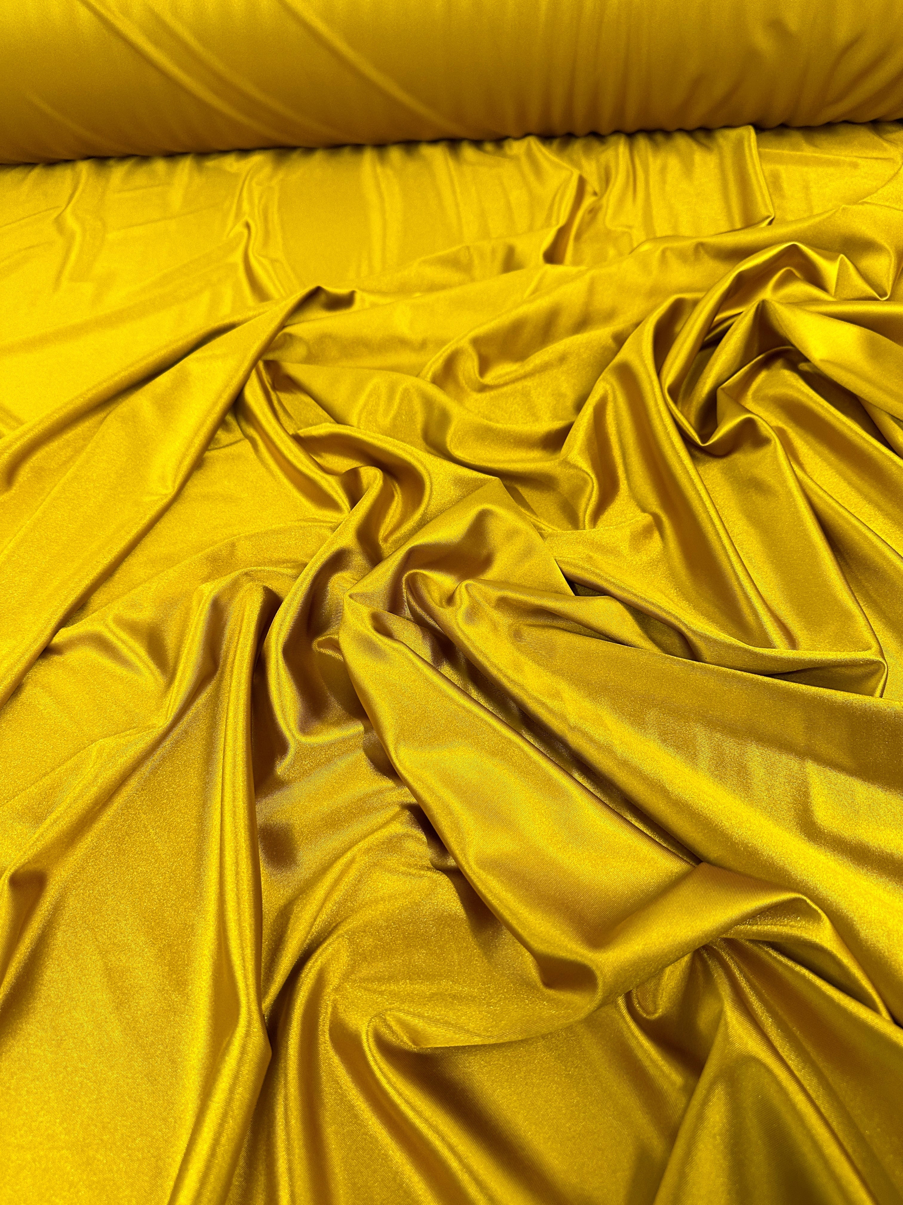 mustard shiny nylon spandex, gold shiny nylon spandex, gold milliskin fabric, yellow shiny nylon spandex, yellow spandex, 4 way stretch spandex, lycra spandex. activewear fabric, athleisure fabric