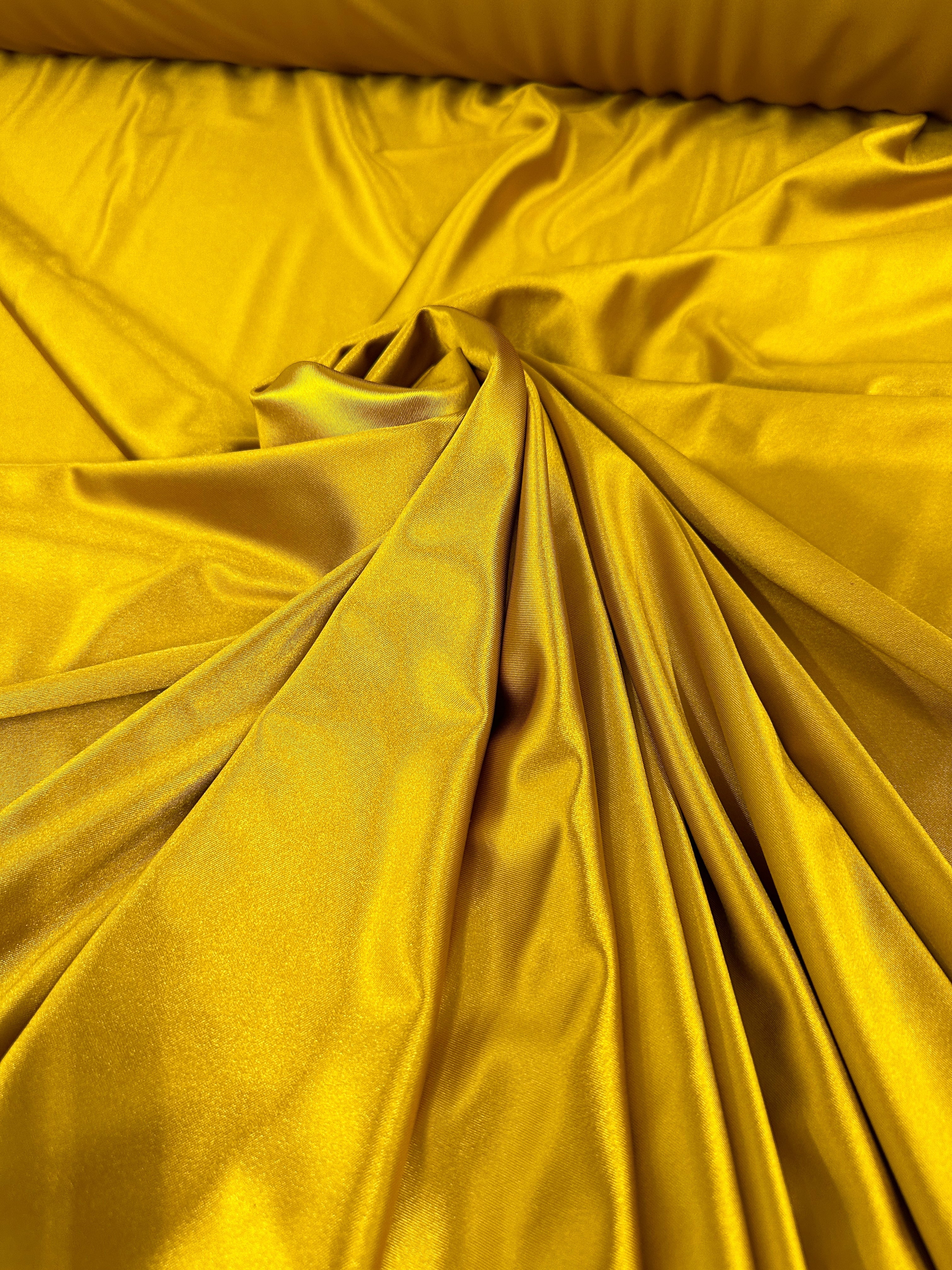 mustard shiny nylon spandex, gold shiny nylon spandex, gold milliskin fabric, yellow shiny nylon spandex, yellow spandex, 4 way stretch spandex, lycra spandex. activewear fabric, athleisure fabric