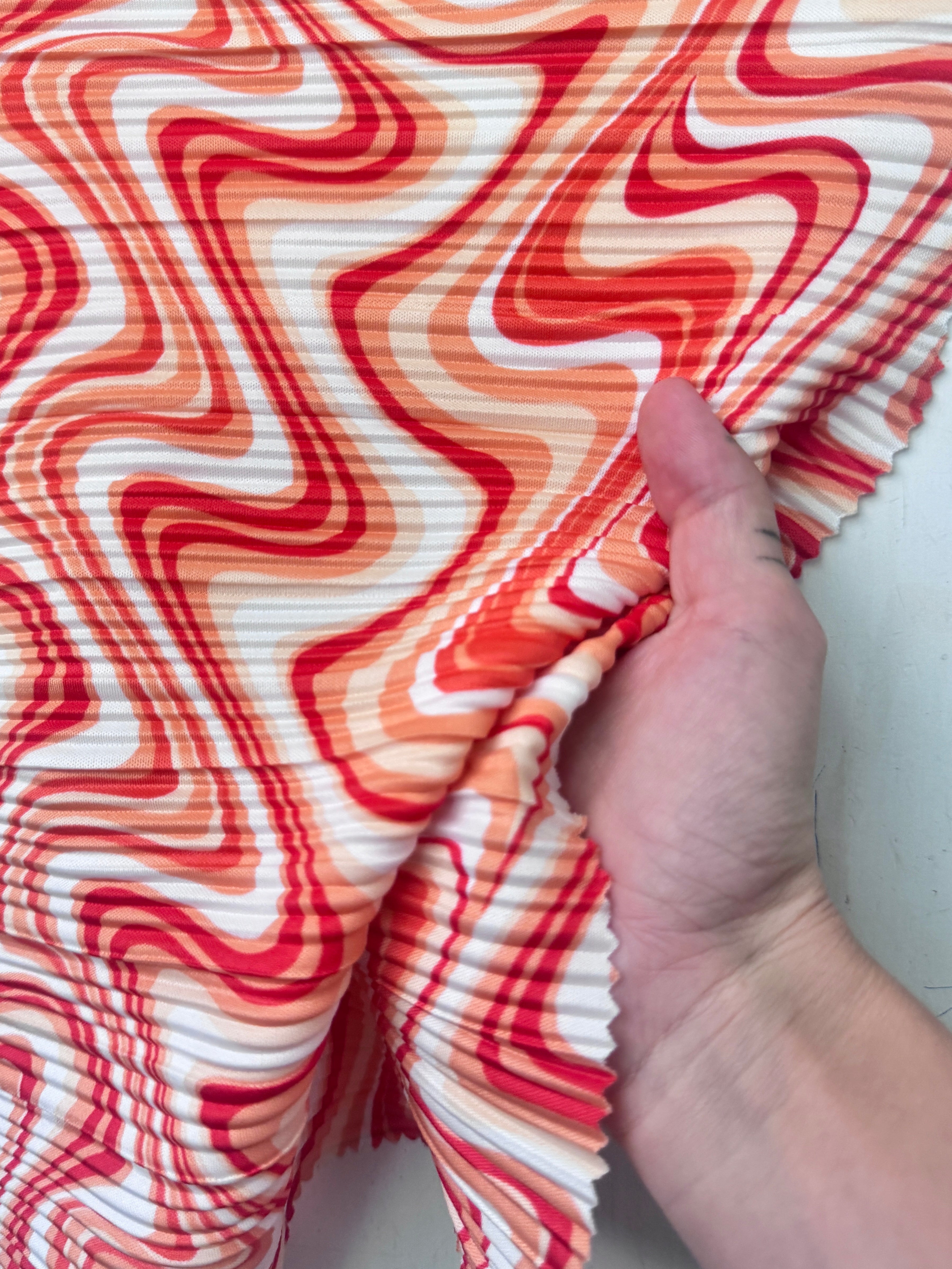 orange print Pleated Knit, orange pleated knit, orange textured knit, printed fabric, print pleated fabric, pleated spandex, spandex fabric, kiki textiles, sewing