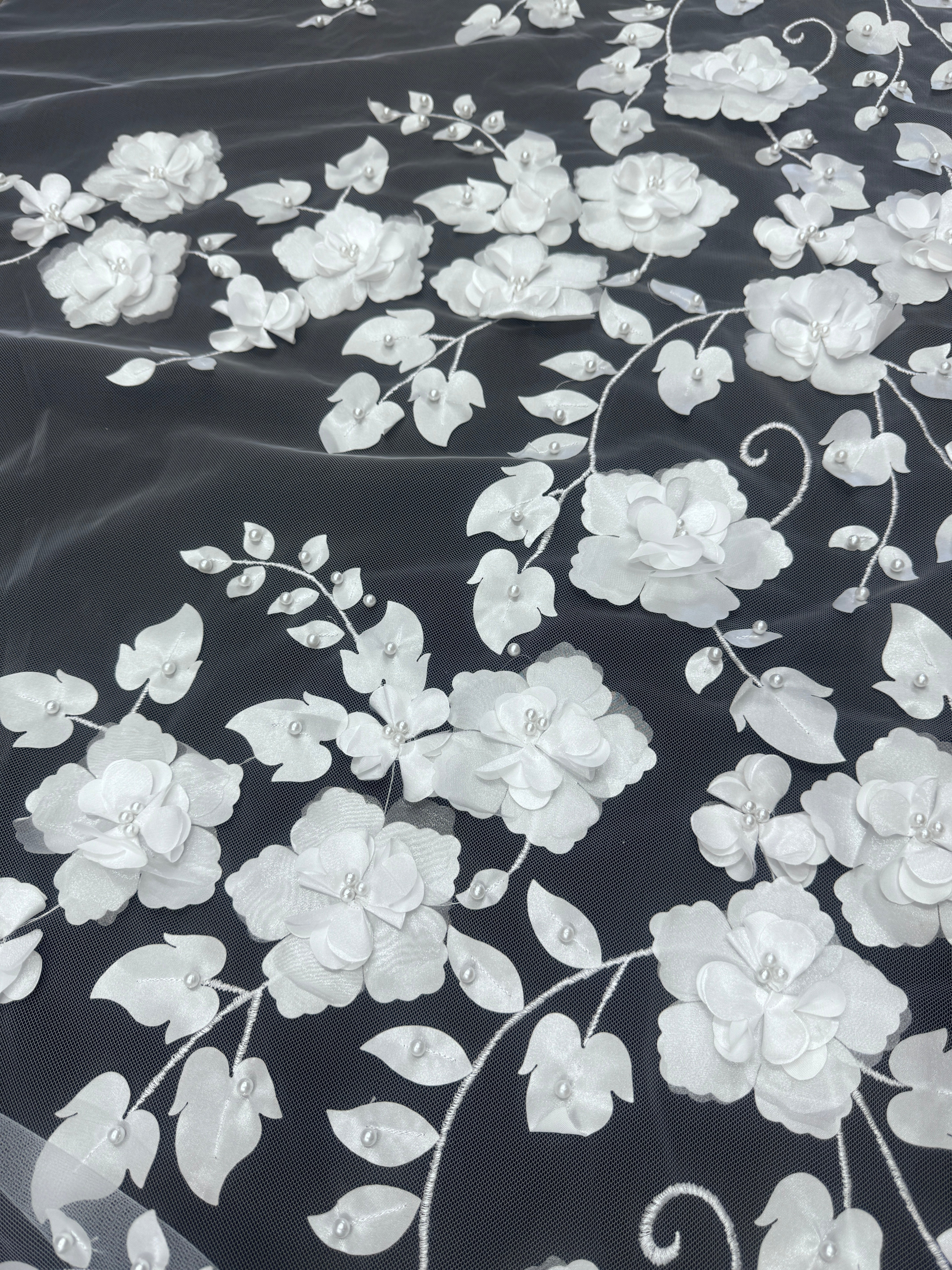 3d white flower on a white sheer fabric over the black background 