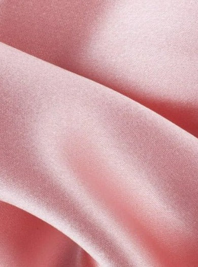 close up of dusty rose satin fabric with single fold 