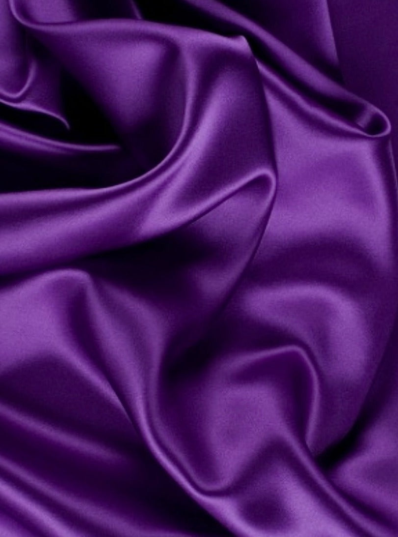 Close-up of purple satin fabric with folds