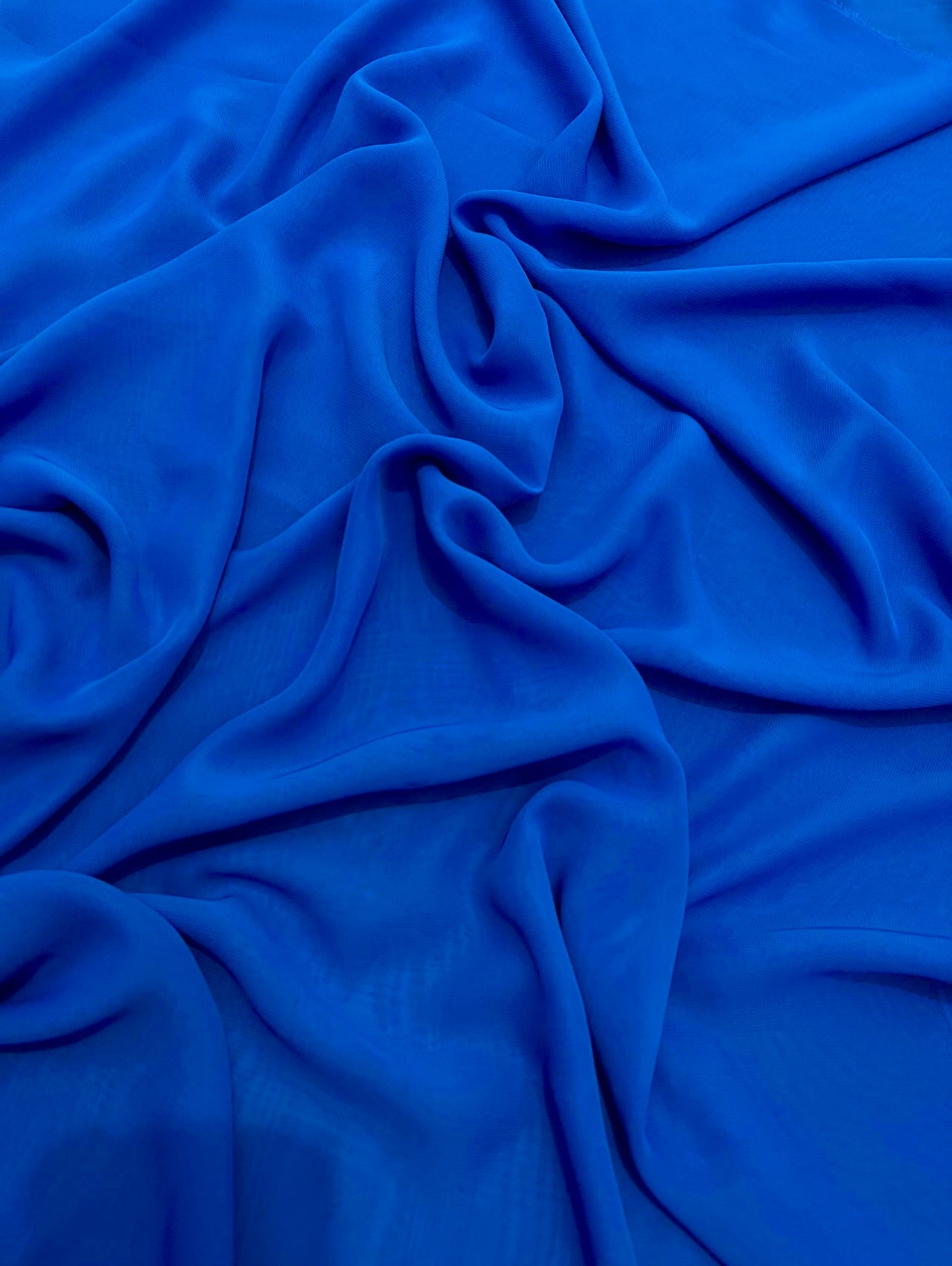 close up of dark blue royal chiffon fabric 