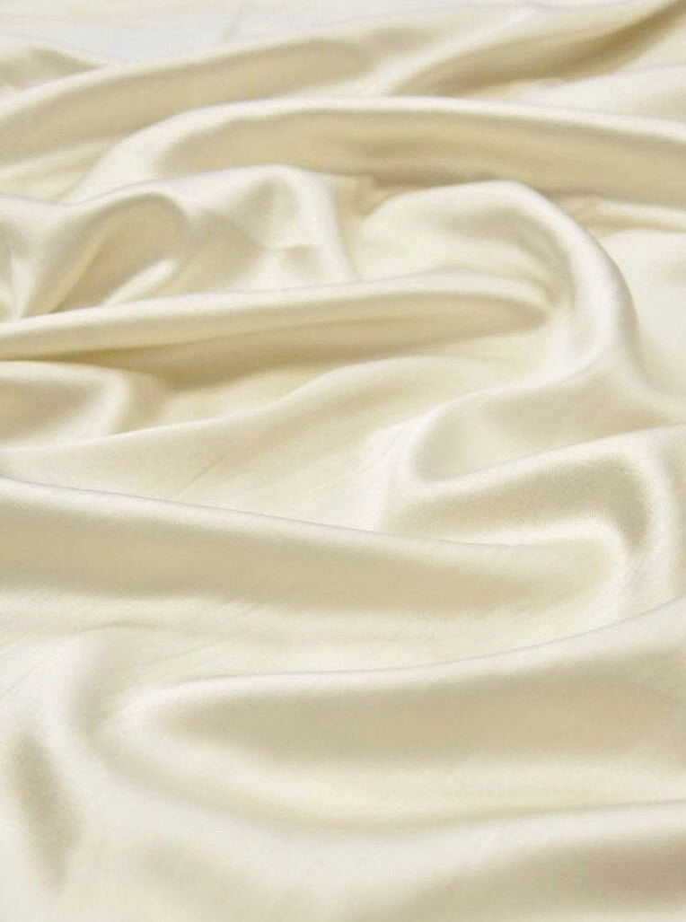 close up look of ivory satin fabric with drapes 