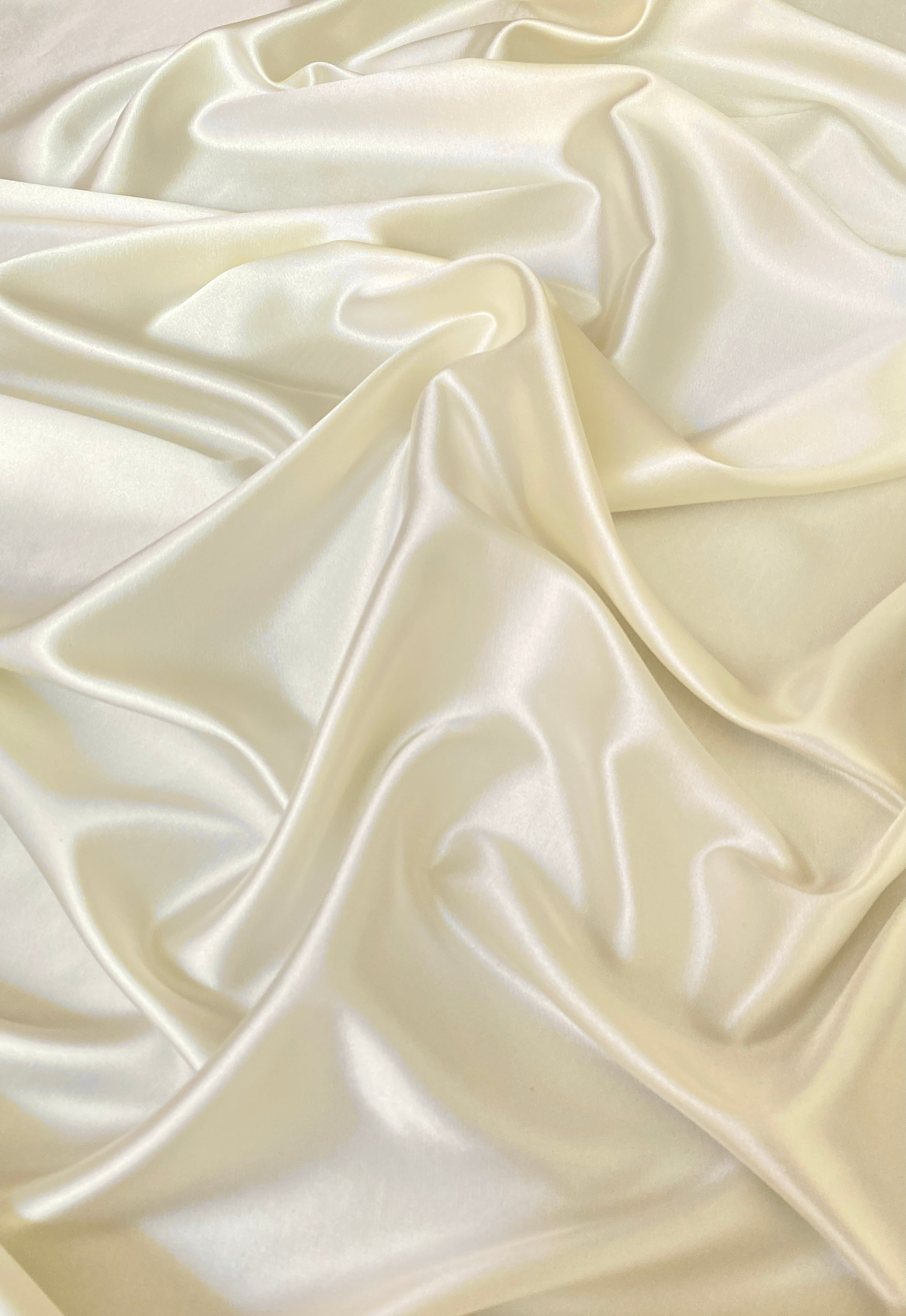 close up of ivory stretch silk satin fabric by the yard 