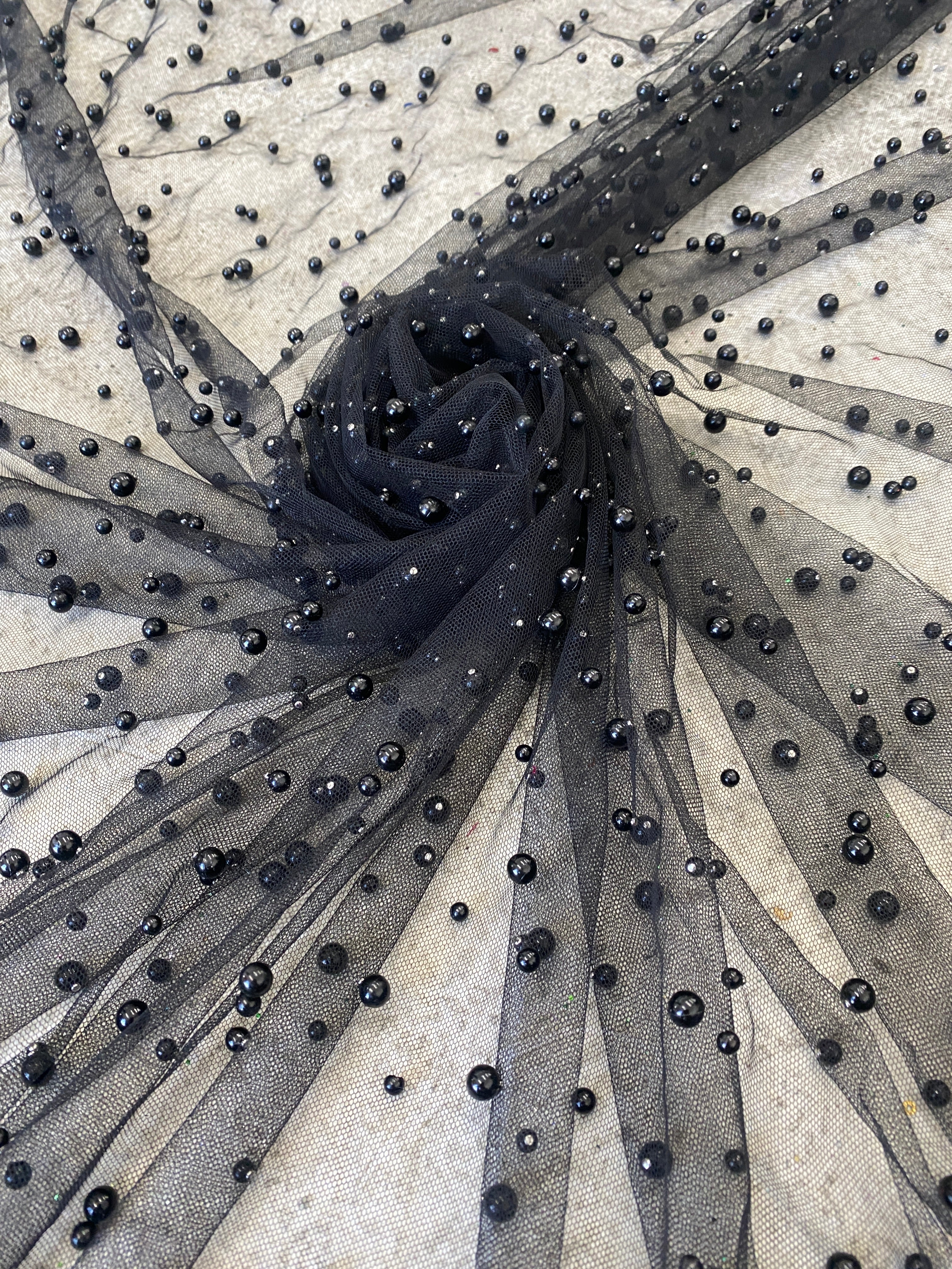 closer look of black pearl tulle folded in a flower shape 