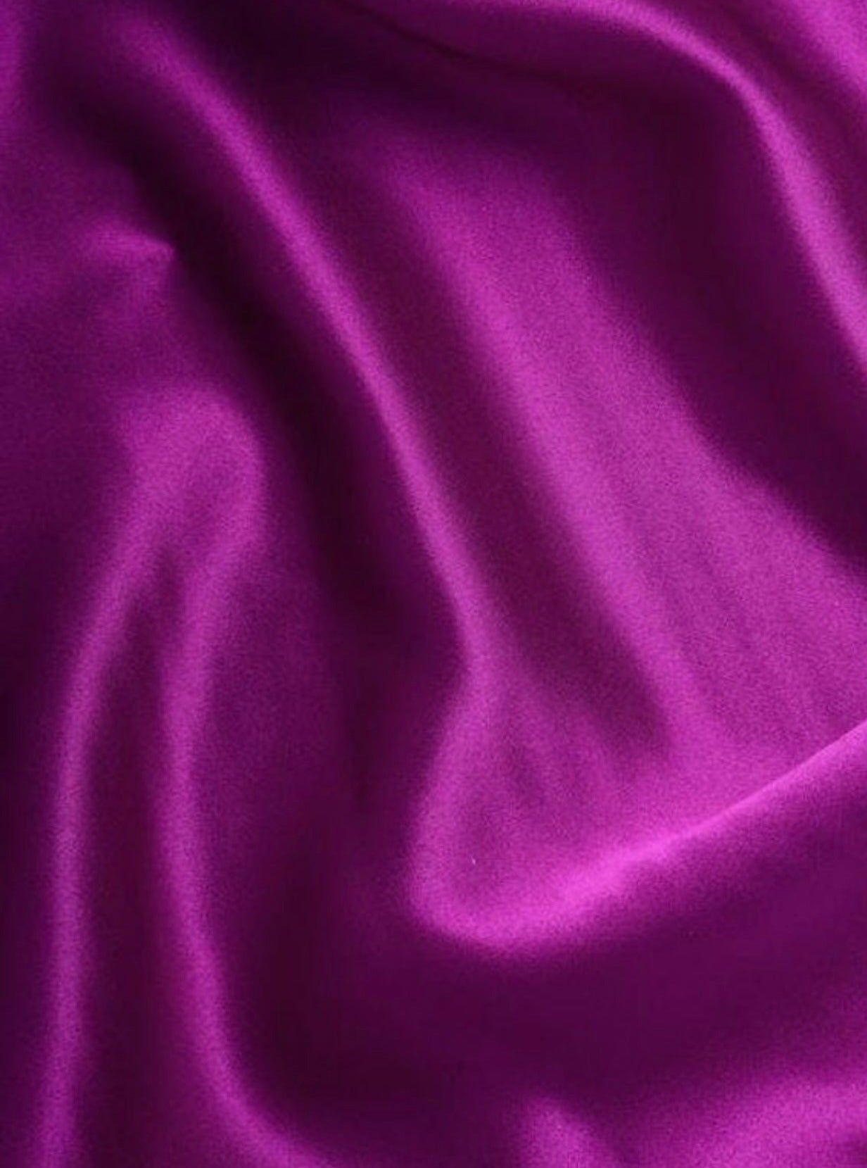 close up of purple satin fabric magenta silky stretch 