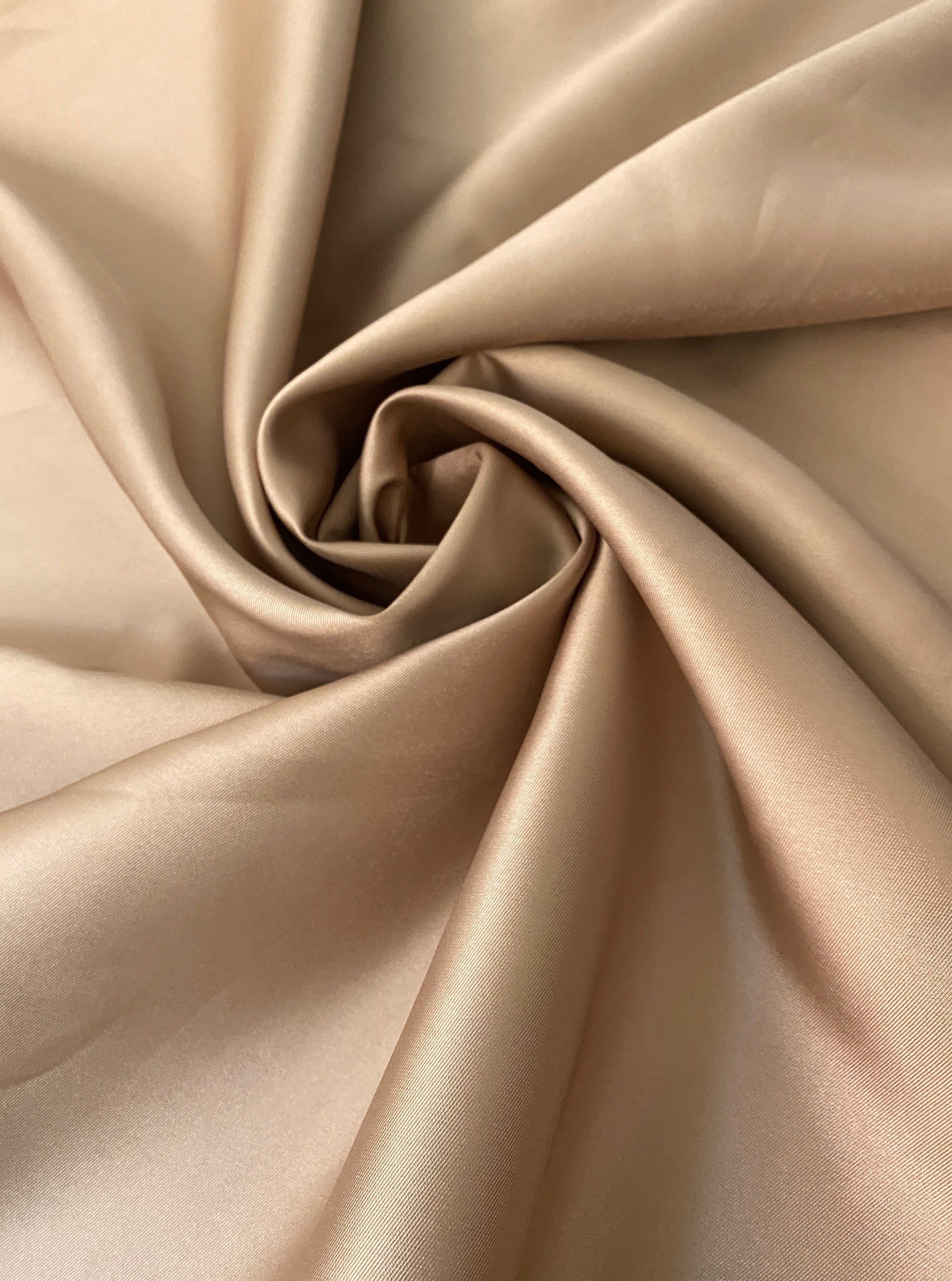 satin rolled up mikado gold fabric closeup 